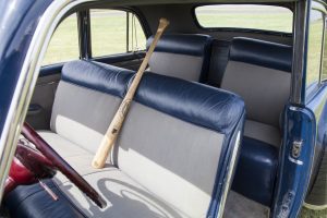 The baseball bat is just part of Lonnie's collection. It didn't belong to Babe Ruth. The interior colors were specifically designed to reflect the colors worn by the New York Yankees at that time.